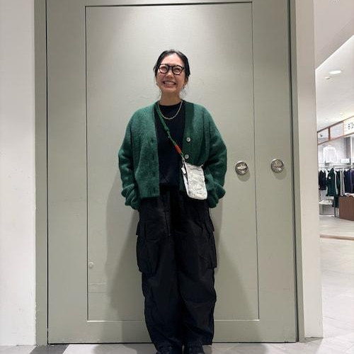 The cardigan is wide, short and bo...