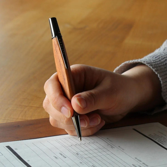 Triangular shaped wooden ballpoint pen that fits perfectly in your hand